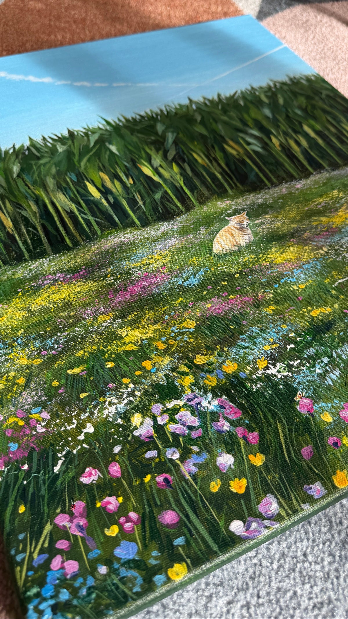 Painting of a cat in a field with flowers and corn